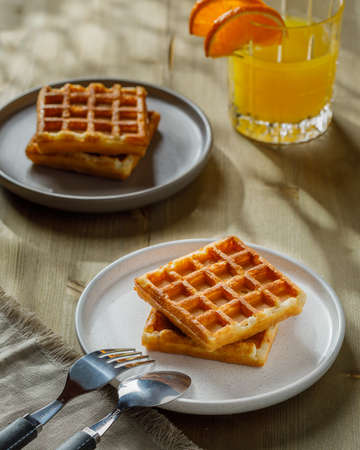 Homemade Belgium waffles served on a plate. Selective focus.の写真素材