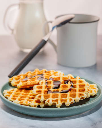 Homemade Belgium waffles served on a plate. Selective focus.の写真素材