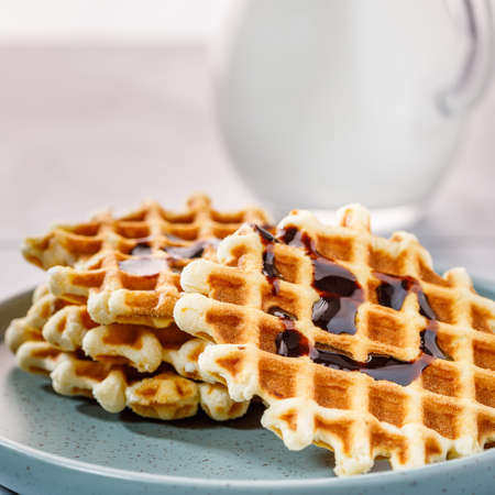 Homemade Belgium waffles served on a plate. Selective focus.の写真素材