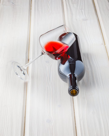 Still life with glass of red wine on wooden background, copy space