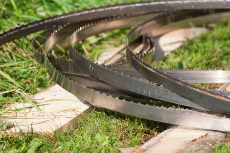 band-saw blades stacked on the ground