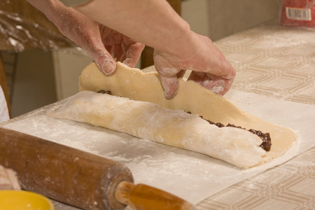 Women making homemade roulette with chocolate cream