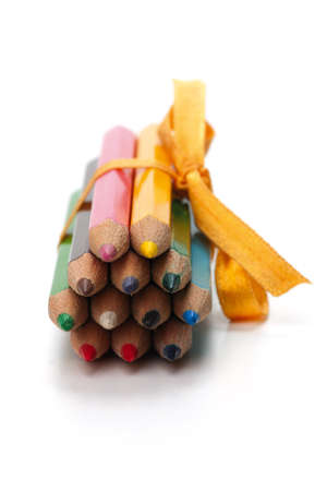 Colored pencils bound together with ribbon. Isolated on white background.の写真素材