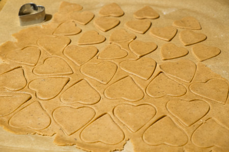 Homemade Gingerbread Cookies cut into Christmas heart shapes ready for baking