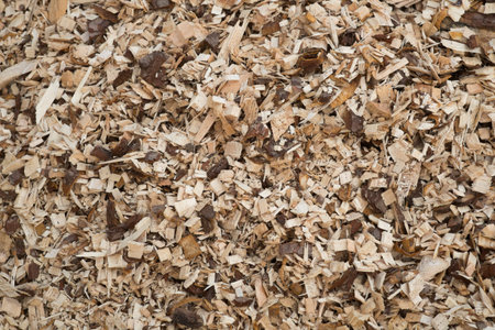 A pile of pine wood shavings with a blue sky in the background. Solid fuel for stoves from...