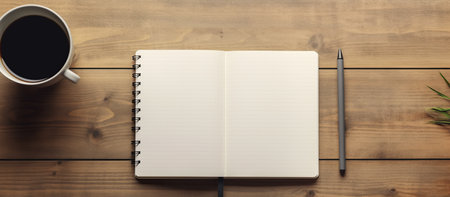 Top view of coffee cup and notebook on wooden table with copy spaceの素材