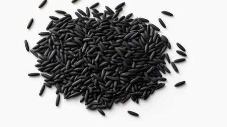 Pile of black wild rice isolated on white background. Top view.の素材