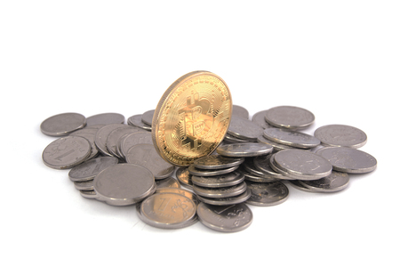 Bitcoin golden on top of other coins isolated on white backgroundの写真素材