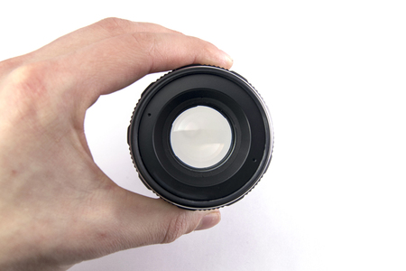 photo lens in hand at the lumen on a white backgroundの写真素材