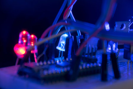 breadboard arduino nano prototyping board transistors resistors LEDs red and blue in glow in the...