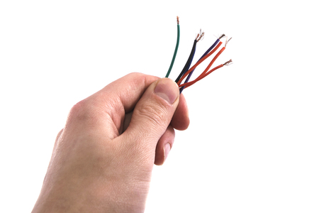 bunch of colored wires, fingers on whiteの写真素材