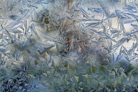 Beautiful natural frosty pattern on winter window.の写真素材