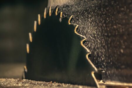 Carpenter tools on wooden table with sawdust. Circular Saw.の写真素材