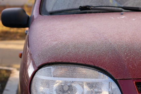 Frozen windshield wiper on car. Frozen windshield. car windshield in winter. Frozen front window of...