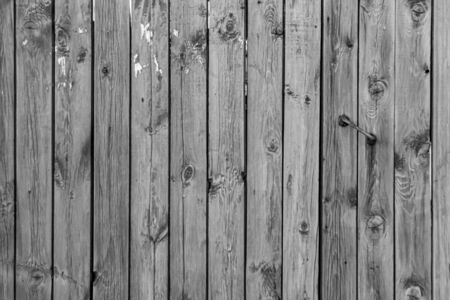 Old outdoor gray wooden wall background photo textureの写真素材