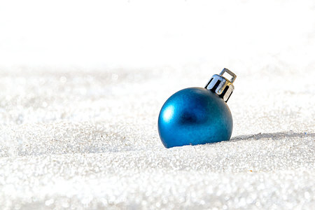 one blue christmas tree ball on white snowの写真素材