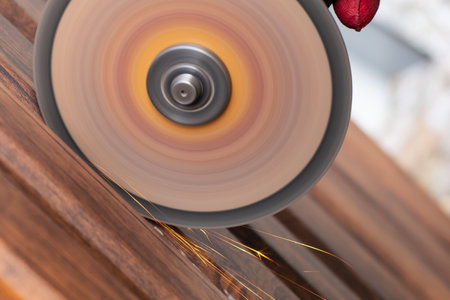 sawing metal with a hand circular saw Close-up, bright flashes flying in different directions. safety violation, without protective coverの写真素材