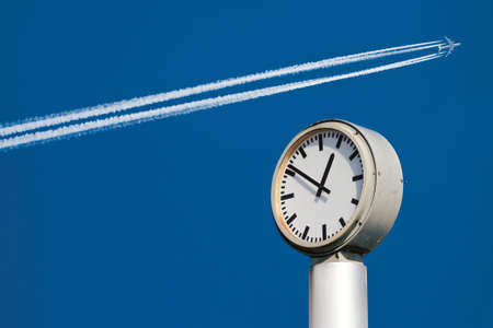 Time and speed. Clock and airplaneの写真素材
