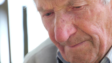 Face portrait of old unhappy frowning senior man.