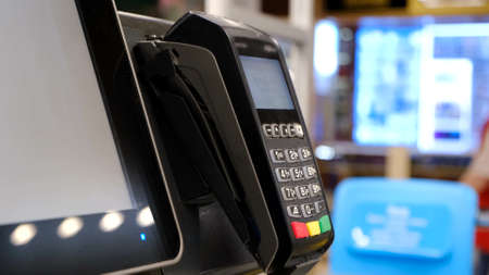 Payment by credit card at the supermarket. Wireless money transaction.の写真素材