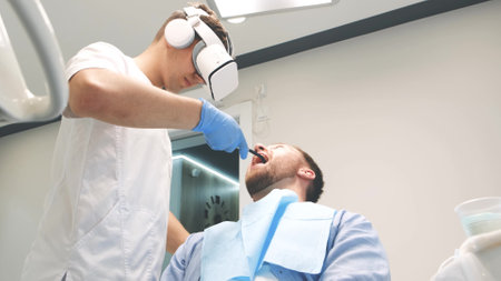 Dentist who uses new technology of dental treatment with the help of virtual reality glassesの写真素材
