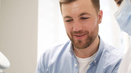 Handsome young man visits dentist, prevention and treatment of teeth. Modern dental clinic