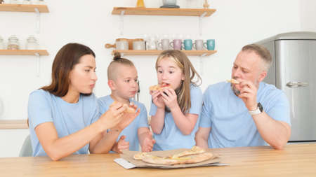 Family taking slices of pizza, fast food, leisure, lifestyle. Pizza delivery home. Dinner familyの写真素材