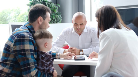 A large family takes a mortgage from a bank, buying a home on credit. The concept of lending, bank