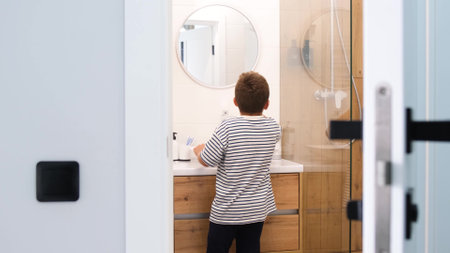 A little boy brushes his teeth before going to bed. Dental health in children.の写真素材