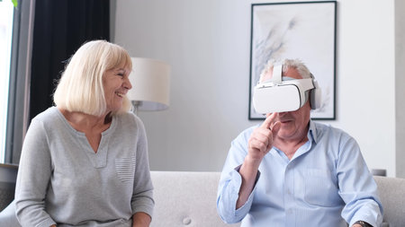 Grandfather in virtual reality glasses. The concept of the future.