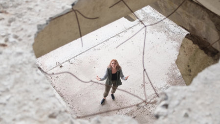 A Ukrainian girl sings on the ruins of war. Consequences of the war in Ukraine.の写真素材