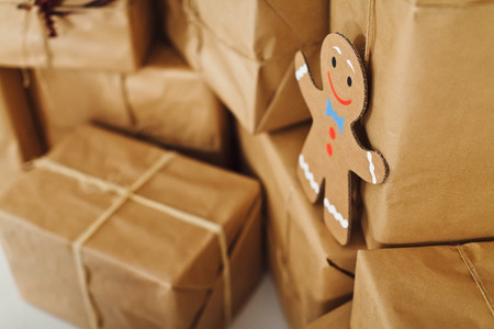 Funny smile-figure of paper on the background of present boxesの写真素材