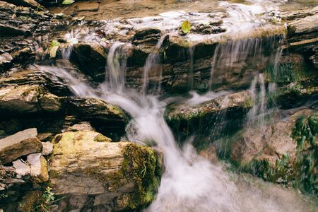 A wonderful waterfall in the mountains. Findings traveling.の写真素材