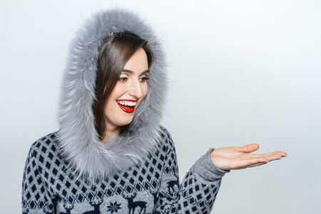 Young and beautiful woman holding a nice Christmas present.  hand  emotion.の写真素材