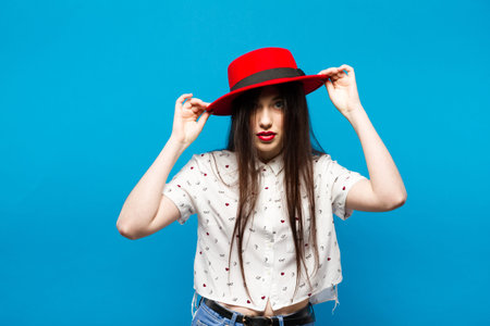 Red female felt hat. Isolated on blue background. Happy and fresh