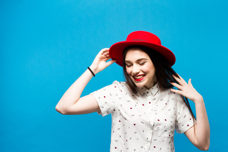 Red female felt hat. Isolated on blue background. Happy and freshの写真素材