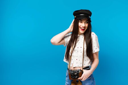 fashion portrait of stylish photographer girl holding vintage retro camera.の写真素材