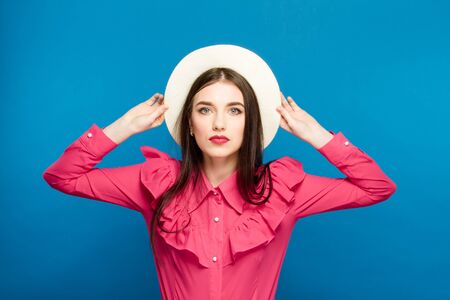 Beautiful woman in hat. Retro fashion. Blue Backgroundの写真素材