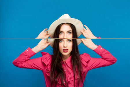 Beautiful woman in hat. Retro fashion. Blue Backgroundの写真素材