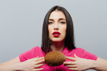 Girl is holding a coconutの写真素材
