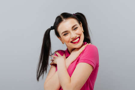 Happy pretty girl over grey background Beautiful happy woman at celebration party , celebrating concept.の写真素材