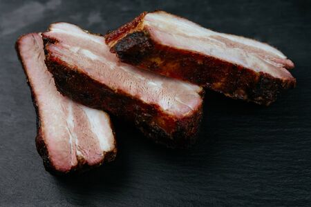 Spicy hot grilled spare ribs from a summer BBQ. Black backgroundの写真素材