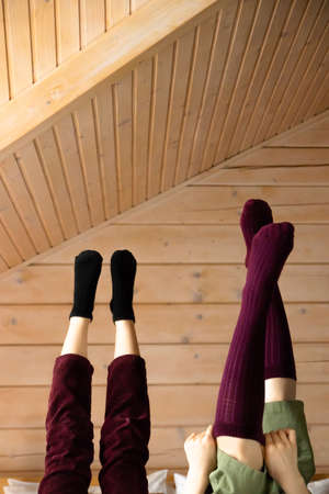 Socks close up. The guy and the girl on a wooden ladder sit. For advertising. High quality photoの写真素材