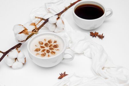 Coffee cappuccino with cinnamon and anise stars on white backgroundの写真素材