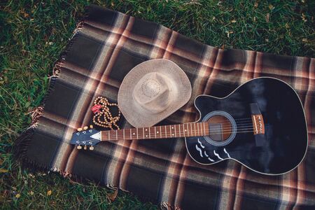 Guitar, basket, sandwiches, plaid and juice in a blossoming garden. Vintage tender background. Romance, love, dateの写真素材