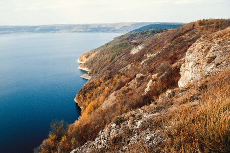 Majestic sunset in the mountains landscape over a calm lakeの写真素材