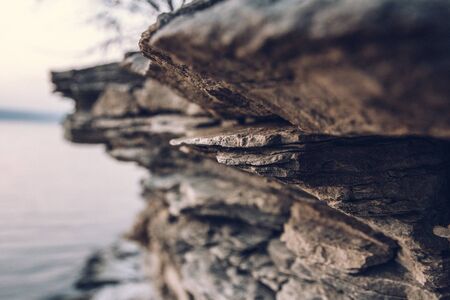 Surface of an stone wall. Black Stone background. Rock texture. Rock pile backgroundの写真素材