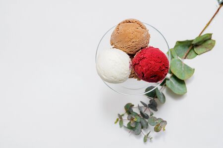 Bowl of various colorful ice cream balls on white background. From top viewの写真素材