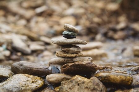 Stones pyramid on pebble beach symbolizing stability, zen, harmony, balance. Shallow depth of fieldの写真素材
