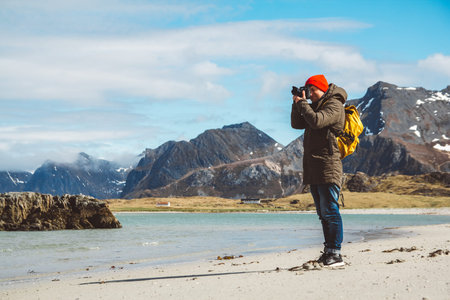 Traveler is a professional photographer taking over the landscape photo landscape. Wearing a yellow...